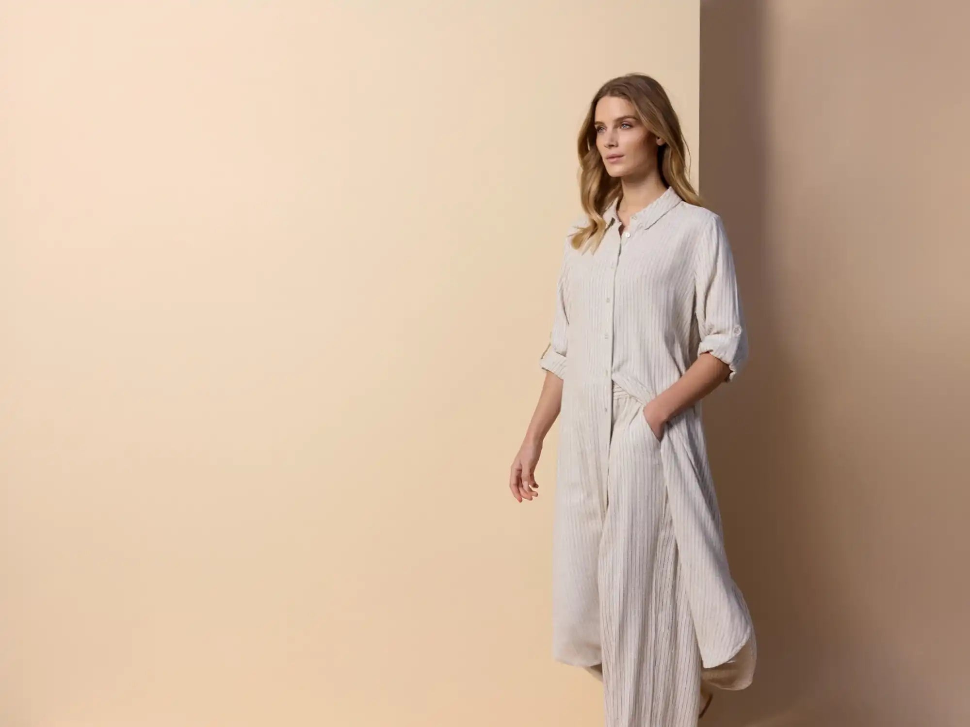 Light-colored, long-sleeved dress.